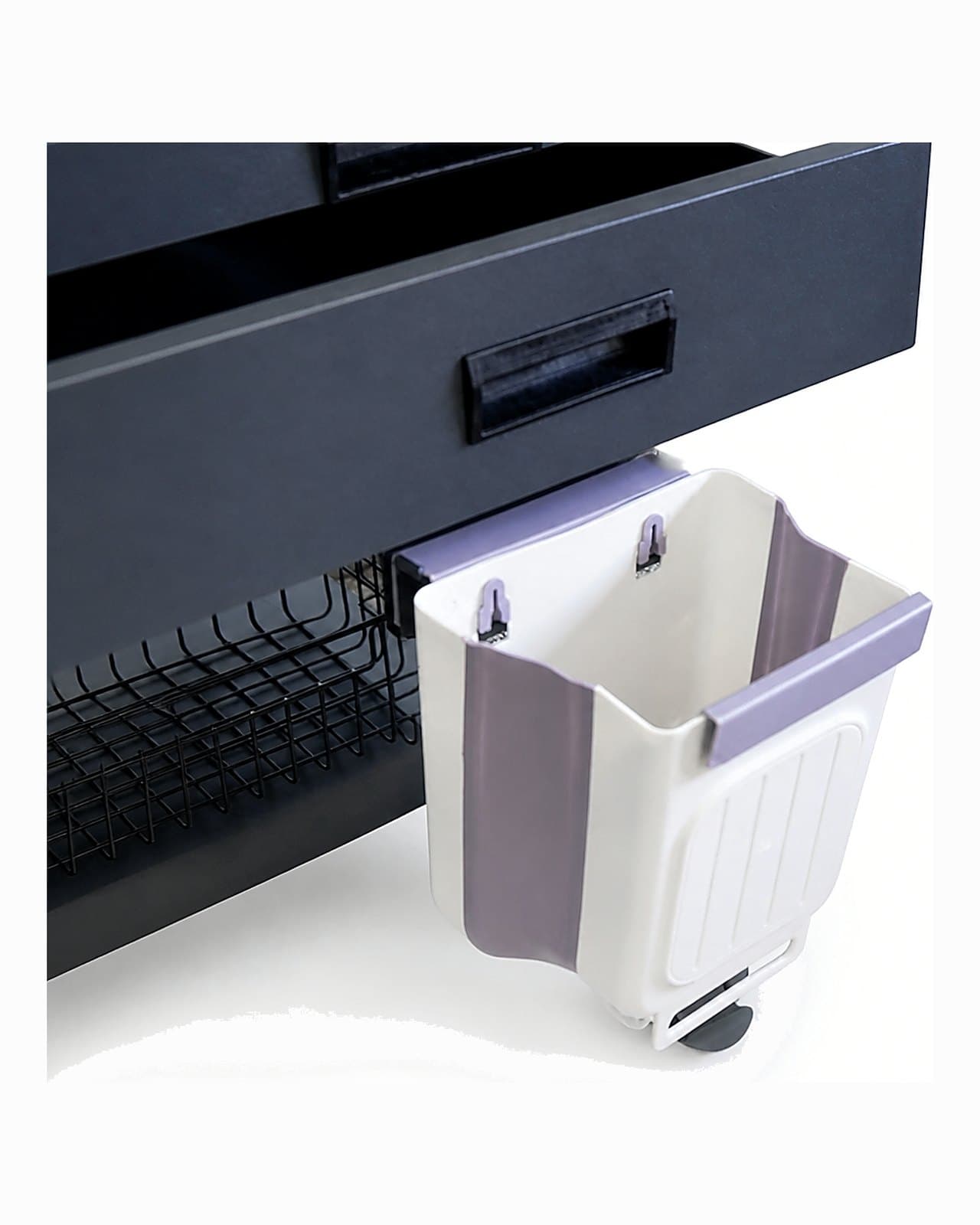 Close-up of the IVT-300 waste bin swung open on its hanger, beneath the drawer unit